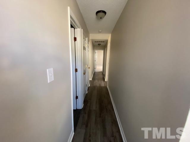 506 Homestead Park Drive Apex, NC 27502 - Photo 11 of 18 a view of a hallway with a wooden floor