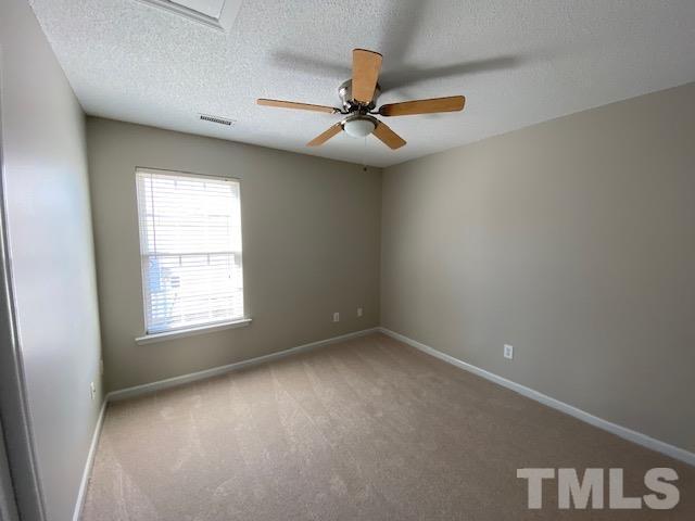 506 Homestead Park Drive Apex, NC 27502 - Photo 12 of 18 an empty room with a window and a fan