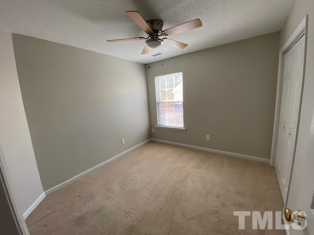 506 Homestead Park Drive Apex, NC 27502 - Photo 13 of 18 an empty room with a window and a ceiling fan