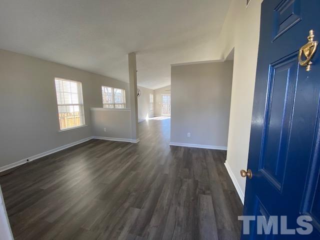 506 Homestead Park Drive Apex, NC 27502 - Photo 2 of 18 an empty room with wooden floor and windows