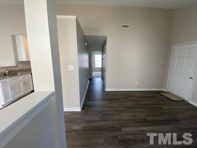 506 Homestead Park Drive Apex, NC 27502 - Photo 7 of 18 a view of a kitchen cabinets and wooden floor