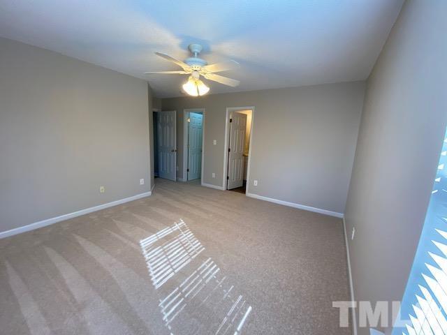 506 Homestead Park Drive Apex, NC 27502 - Photo 9 of 18 a view of an empty room with a chandelier fan