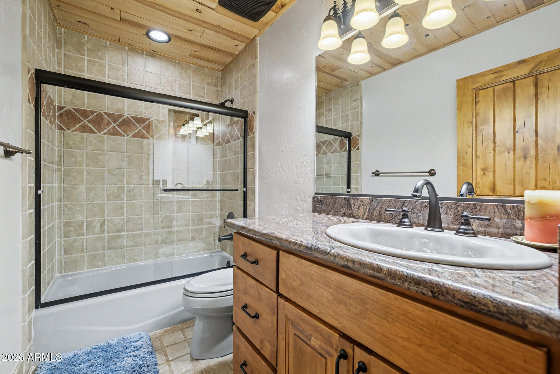 1681 South Jimson Loop Show Low, AZ 85901 - Photo 55 of 105 a bathroom with a granite countertop sink a toilet a mirror and shower
