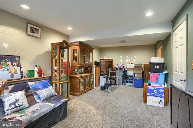 a view of a field with houses in back