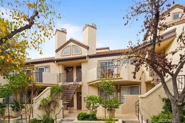 front view of a house with a tree