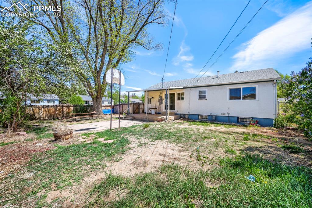 2898 Merry Lane Colorado Springs, CO 80909 - Photo 19 of 19 a backyard of a house with table and chairs