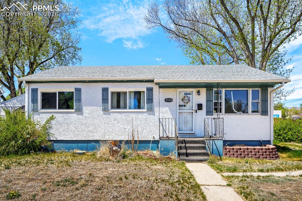 2898 Merry Lane Colorado Springs, CO 80909 - Photo 2 of 19 a front view of a house with garden