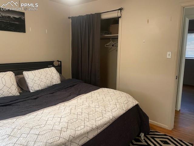 2898 Merry Lane Colorado Springs, CO 80909 - Photo 8 of 19 a bedroom with a bed and a wooden floor