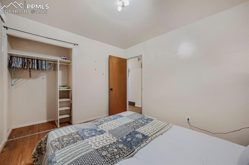 2898 Merry Lane Colorado Springs, CO 80909 - Photo 10 of 19 a bedroom with a bed and a cabinet