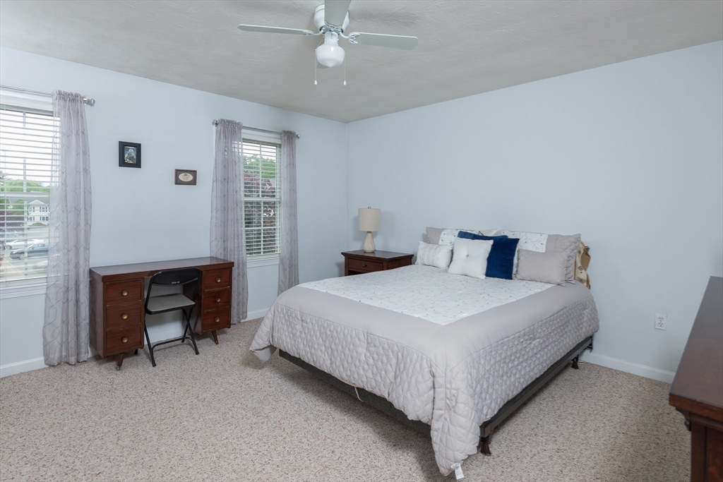3 Boxberry Lane, Unit 3 Rockland, MA 02370 - Photo 11 of 18 a bedroom with a bed and a chandelier