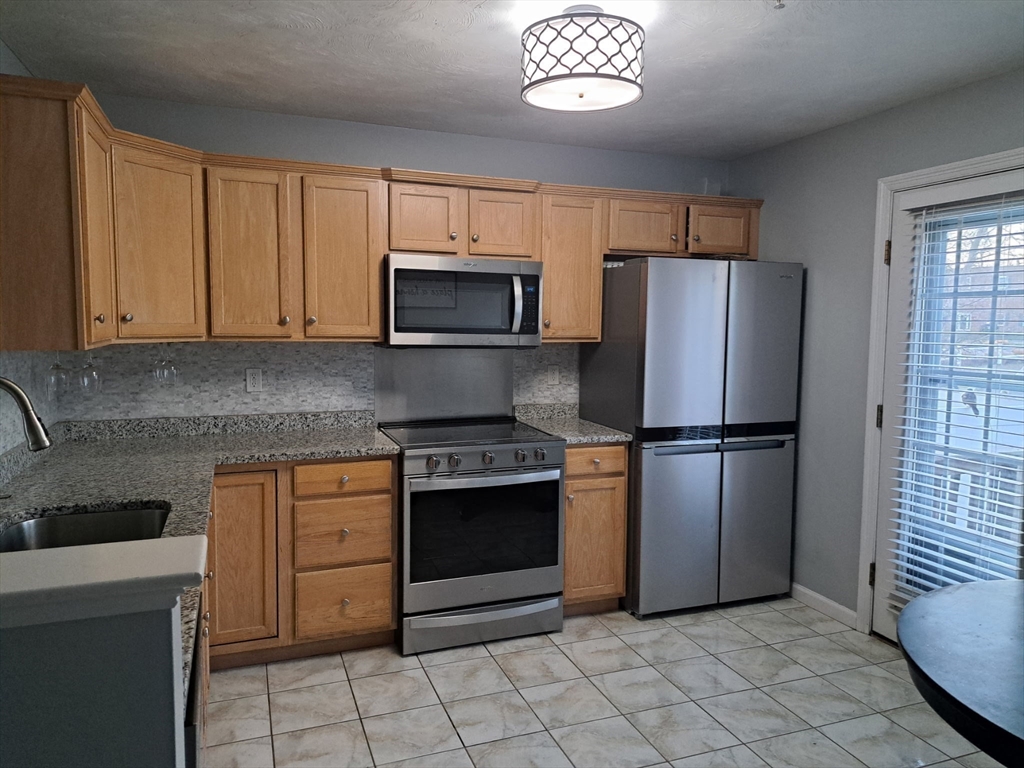 3 Boxberry Lane, Unit 3 Rockland, MA 02370 - Photo 6 of 18 a kitchen with cabinets stainless steel appliances and a counter space