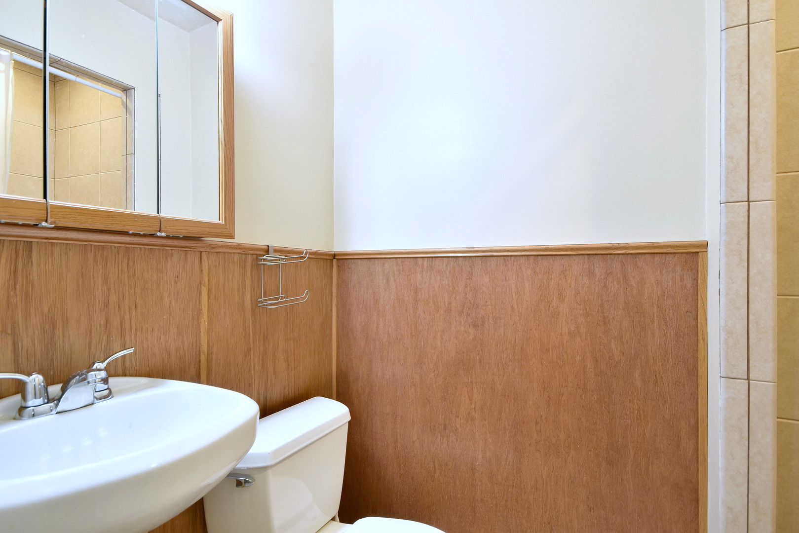 17841 Howe Avenue Homewood, IL 60430 - Photo 19 of 38 a bathroom with a sink a toilet and a mirror