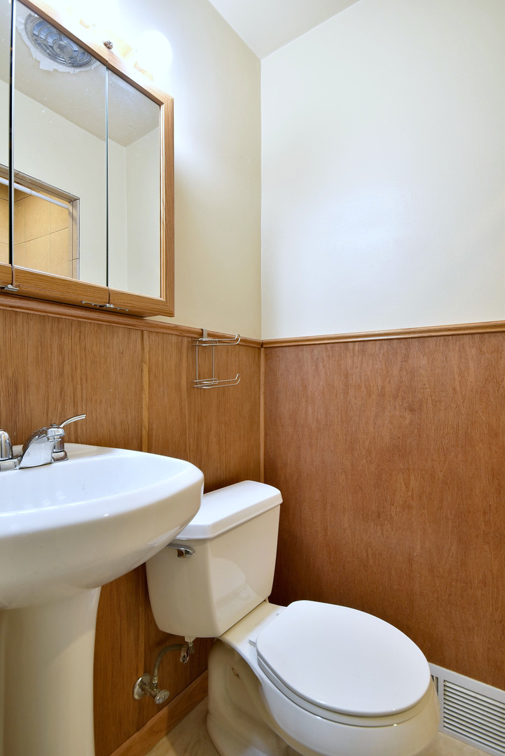 17841 Howe Avenue Homewood, IL 60430 - Photo 20 of 38 a white toilet sitting next to a bathroom sink