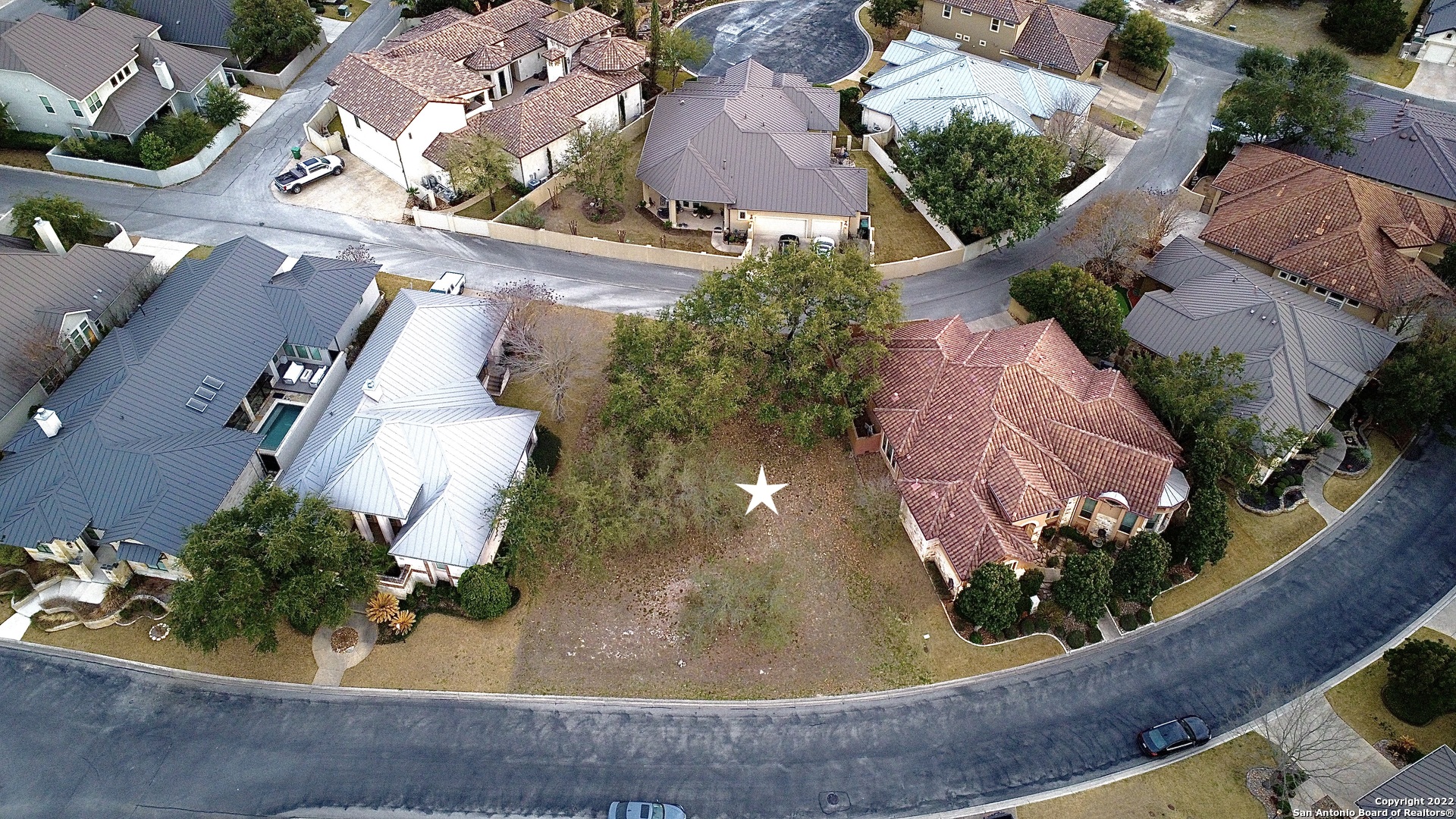 an aerial view of a house with a yard potted plants