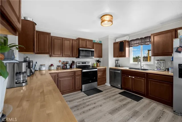 a kitchen with stainless steel appliances granite countertop a stove sink and cabinets