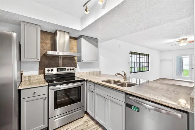 a kitchen with a sink stove and cabinets