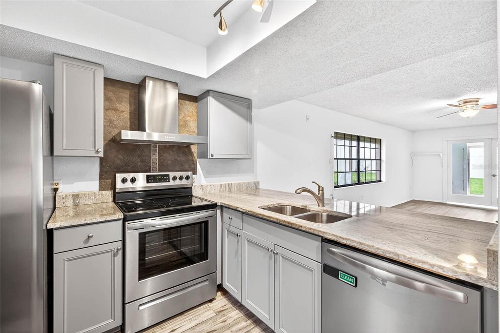 13250 Ridge Road, Unit 21 Largo, FL 33778 - Photo 11 of 36 a kitchen with a sink stove and cabinets