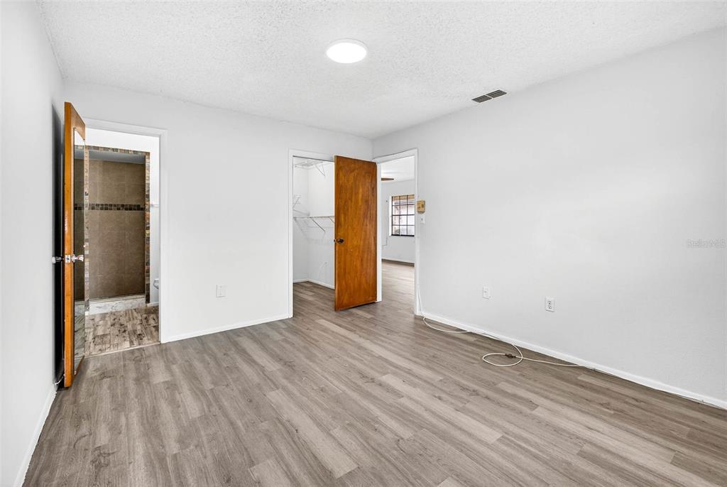 13250 Ridge Road, Unit 21 Largo, FL 33778 - Photo 24 of 36 an empty room with wooden floor and closet