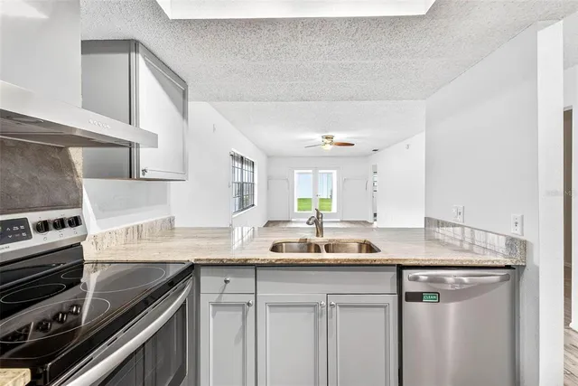a kitchen with a sink stove and cabinets