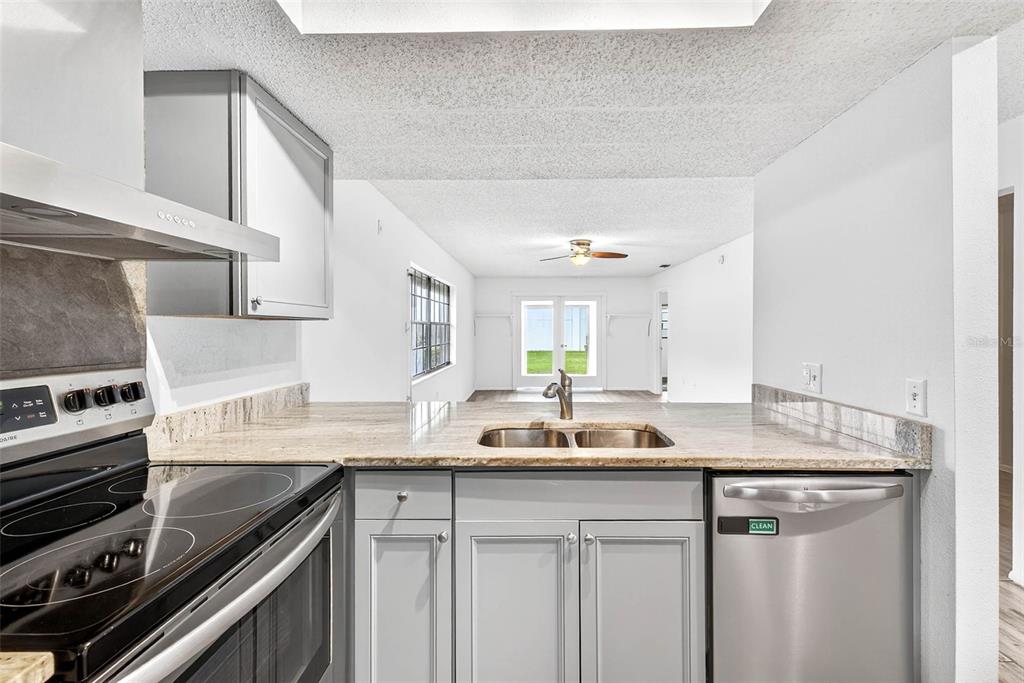 13250 Ridge Road, Unit 21 Largo, FL 33778 - Photo 28 of 36 a kitchen with a sink stove and cabinets