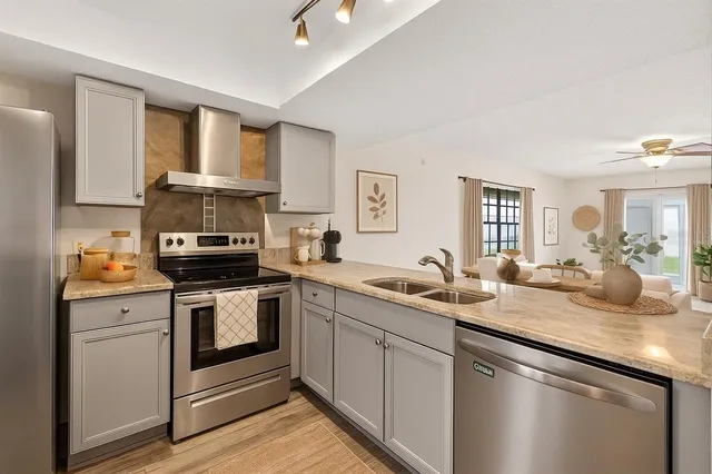 a kitchen with a sink stove and cabinets