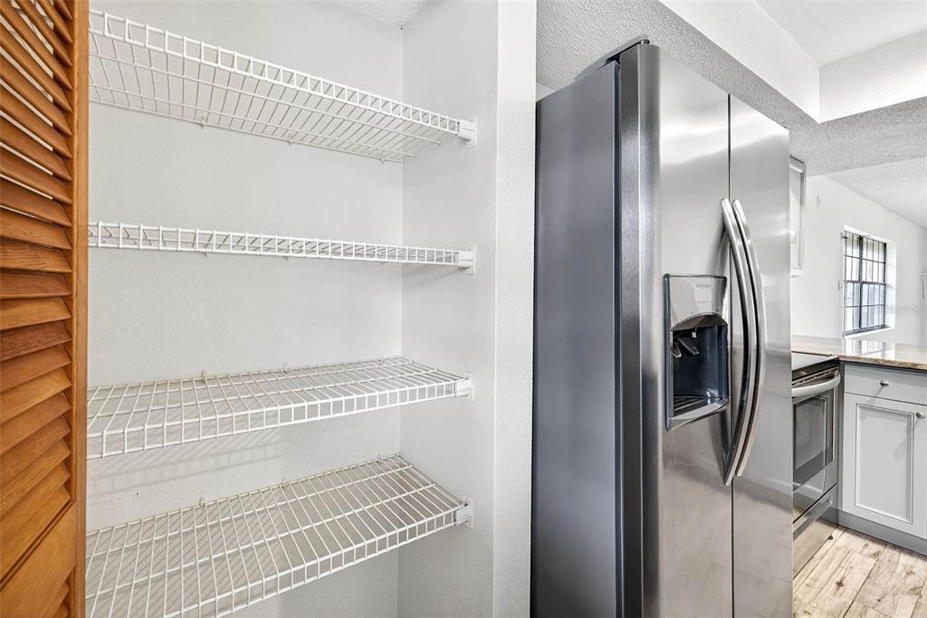 13250 Ridge Road, Unit 21 Largo, FL 33778 - Photo 31 of 36 a view of a kitchen with refrigerator and wooden floor