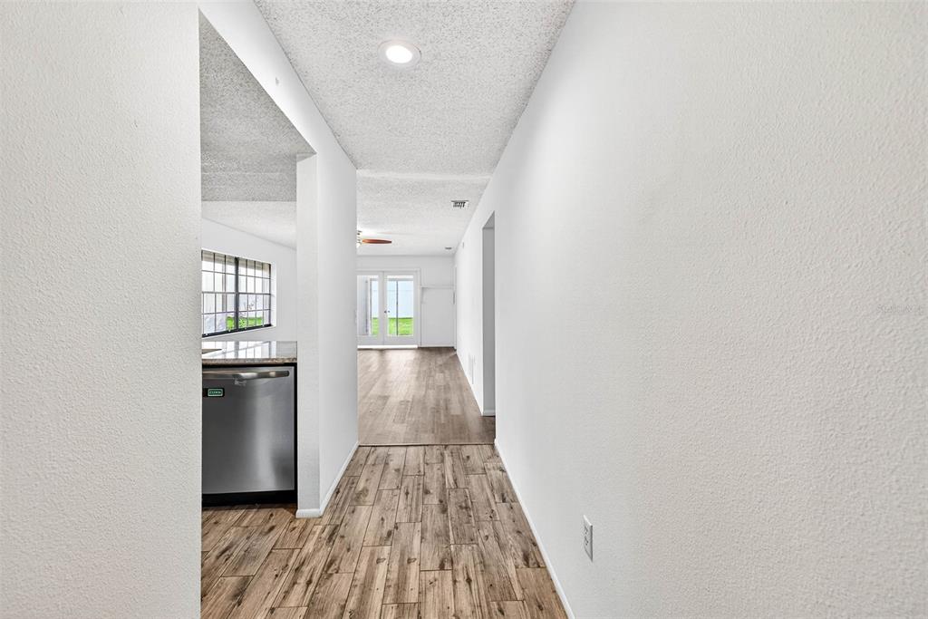 13250 Ridge Road, Unit 21 Largo, FL 33778 - Photo 32 of 36 wooden floor in a hall with an entryway