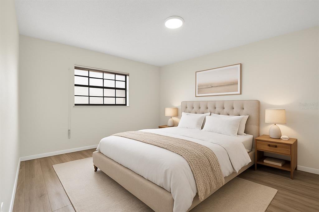 13250 Ridge Road, Unit 21 Largo, FL 33778 - Photo 4 of 36 a bedroom with a bed and a night stand