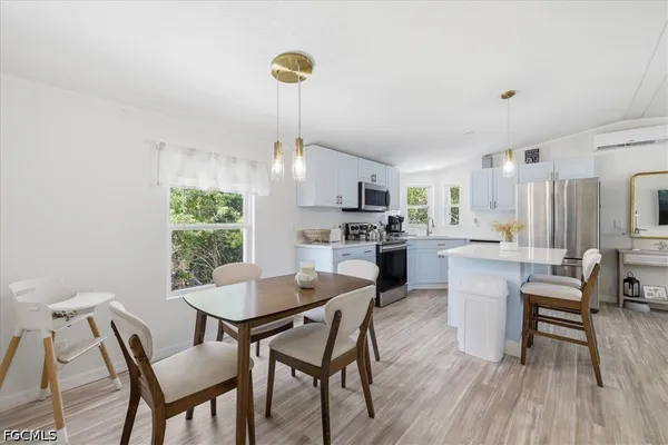 a living room with furniture a wooden floor and a sink