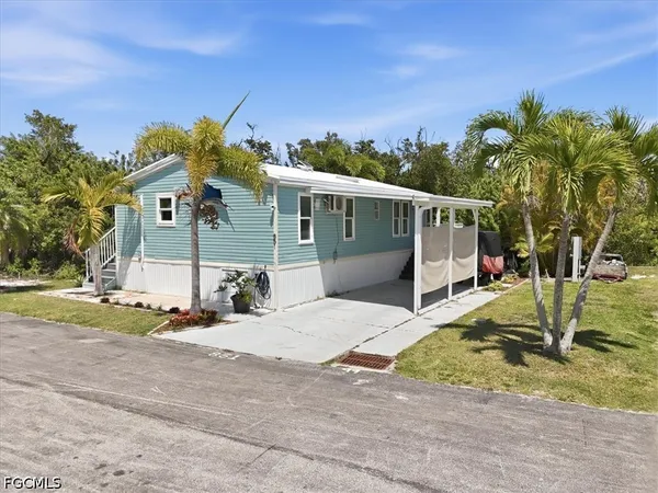 an aerial view of a residential houses with yard