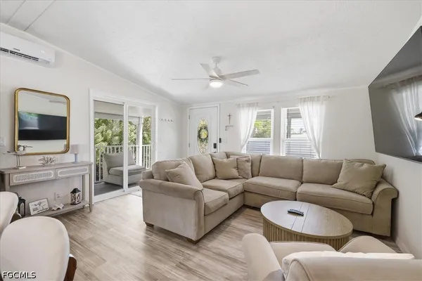 a kitchen with stainless steel appliances granite countertop a stove top oven a sink dishwasher and white cabinets with wooden floor