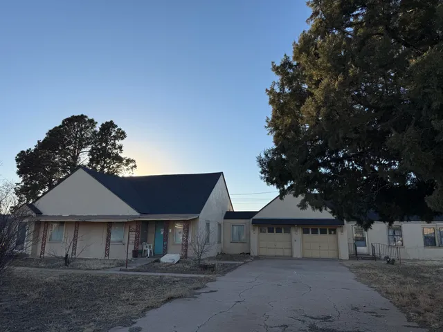 a front view of a house with wooden fence