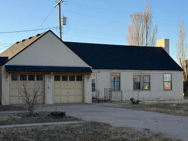 a house that has a tree in front of it