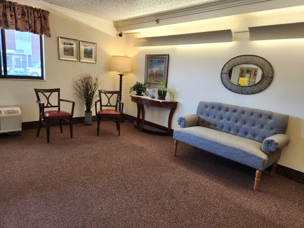 a living room with furniture and a mirror