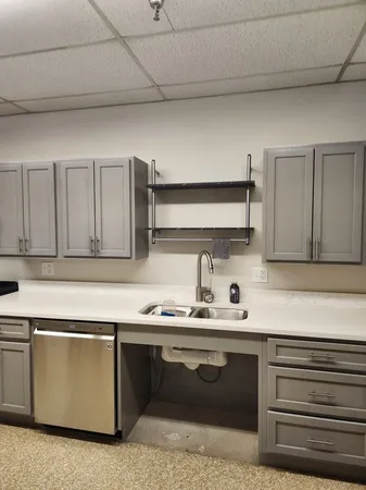 a kitchen with a sink and cabinets