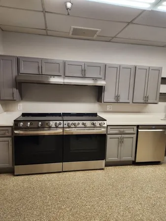 a stove top oven sitting inside of a kitchen