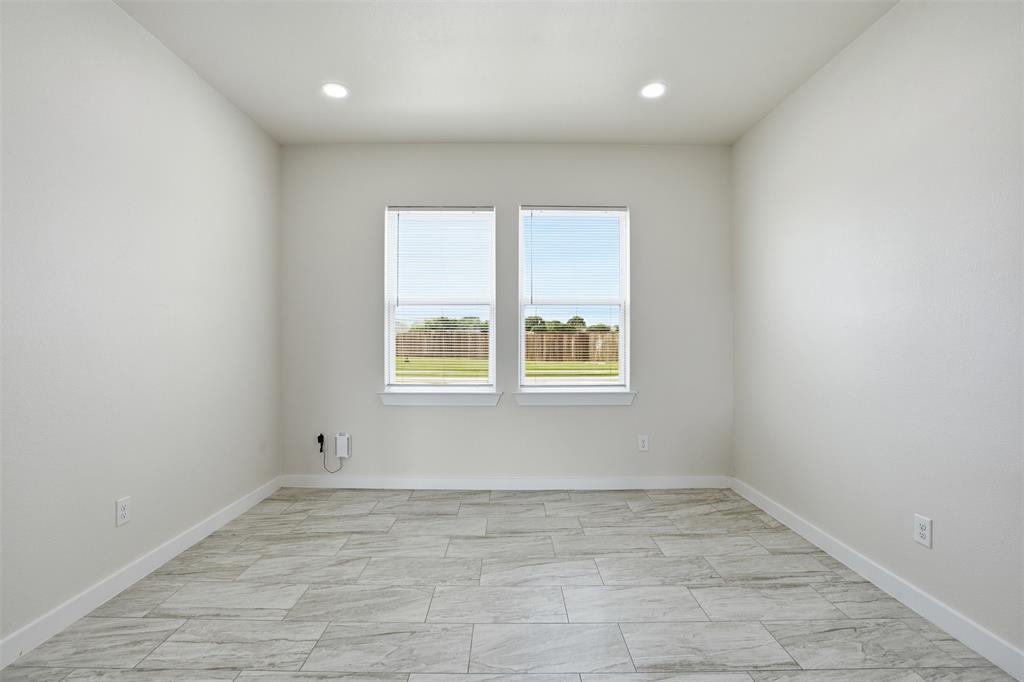 532 Highview Court Godley, TX 76044 - Photo 19 of 39 Neutral-toned interior room featuring tile flooring, white baseboards, and light-colored walls