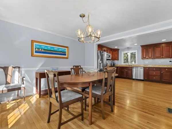 a view of a dining room with furniture and a chandelier