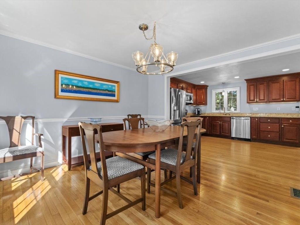 4 Huron Road Acton, MA 01720 - Photo 11 of 32 a view of a dining room with furniture and a chandelier