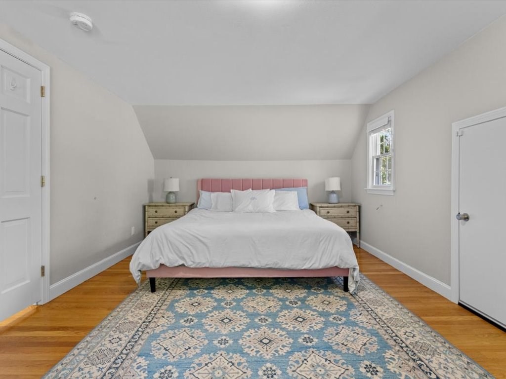4 Huron Road Acton, MA 01720 - Photo 16 of 32 a bedroom with a bed and wooden floor