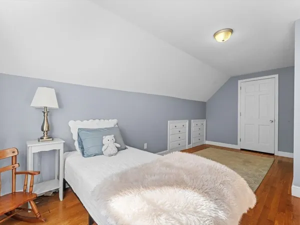 a bedroom with a bed and a lamp