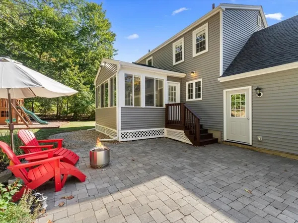 a view of a house with backyard and sitting area