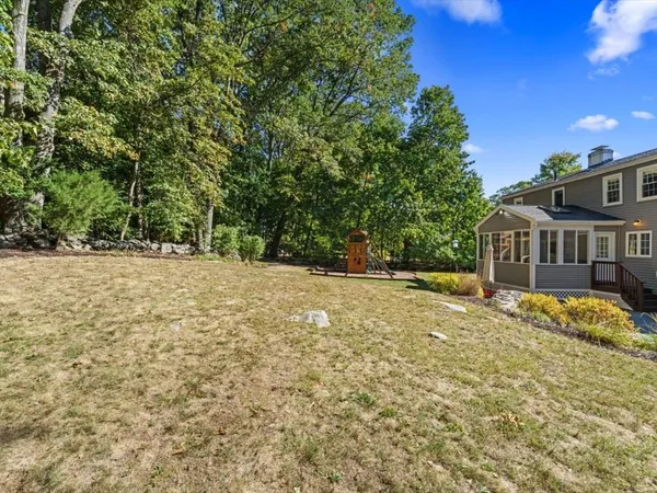 a backyard of a house with large trees