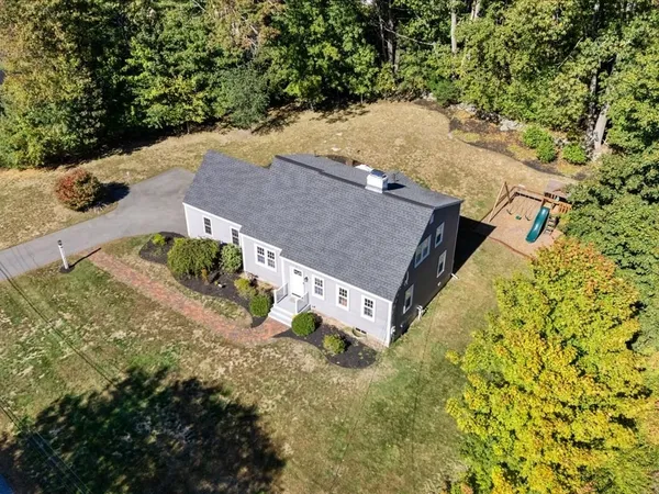 an aerial view of a house with yard