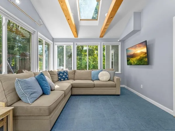 a living room with furniture and a flat screen tv