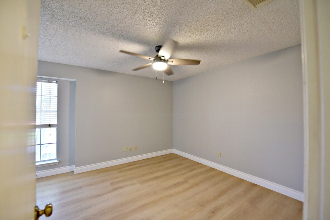 12903 Humphrey Drive Austin, TX 78729 - Photo 14 of 20 wooden floor in an empty room with a window