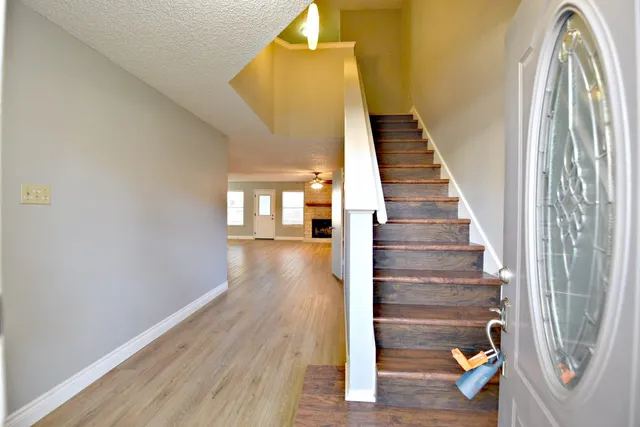 a view of entryway and hall with wooden floor
