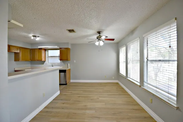 a view of a kitchen with a sink cabinets and outdoor space