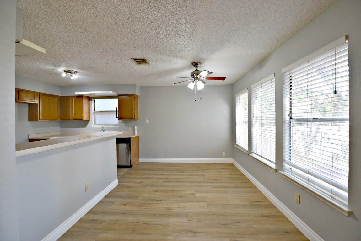 12903 Humphrey Drive Austin, TX 78729 - Photo 7 of 20 a view of a kitchen with a sink cabinets and outdoor space