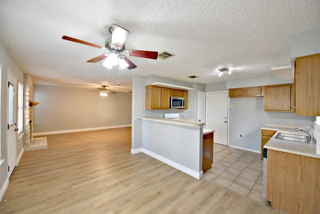 a view of a kitchen with a sink and cabinets